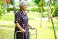 Asian senior or elderly old lady woman patient walk with walker in park : healthy strong medical concept Royalty Free Stock Photo