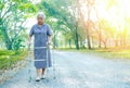 Asian senior or elderly old lady woman patient walk with walker in park : healthy strong medical concept Royalty Free Stock Photo