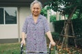 Asian senior or elderly old lady woman patient walk with walker in park at home, healthy strong medical. Royalty Free Stock Photo