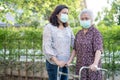 Asian senior or elderly old lady woman walk with walker and wearing a face mask for protect safety infection Covid-19 Coronavirus Royalty Free Stock Photo