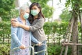 Asian senior or elderly old lady woman walk with walker and wearing a face mask for protect safety infection Covid-19 Coronavirus Royalty Free Stock Photo