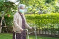 Asian senior or elderly old lady woman walk with walker and wearing a face mask for protect safety infection Covid-19 Coronavirus Royalty Free Stock Photo