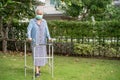 Asian senior or elderly old lady woman walk with walker and wearing a face mask for protect safety infection and kill Novel Royalty Free Stock Photo