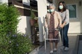 Asian senior or elderly old lady woman walk with walker and wearing a face mask for protect safety infection Covid-19 Coronavirus Royalty Free Stock Photo