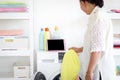 Asian senior elderly old woman housewife doing laundry at laundry room during looking at tablet, grandma using tablet in learning Royalty Free Stock Photo