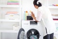 Asian senior elderly old woman housewife doing laundry at laundry room during looking at tablet, grandma using tablet in learning Royalty Free Stock Photo