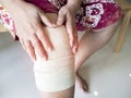 Asian senior or elderly old woman patient with bandage compression knee brace support injury