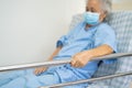 Asian senior or elderly old woman patient lie down handle the rail bed with hope on a bed in the hospital Royalty Free Stock Photo