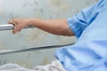 Asian senior or elderly old woman patient lie down handle the rail bed with hope on a bed Royalty Free Stock Photo