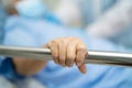 Asian senior or elderly old woman patient lie down handle the rail bed with hope on a bed in hospital Royalty Free Stock Photo