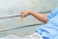 Asian senior or elderly old woman patient lie down handle the rail bed with hope on a bed in hospital Royalty Free Stock Photo