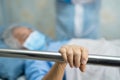Asian senior or elderly old woman patient lie down handle the rail bed with hope on a bed. Royalty Free Stock Photo