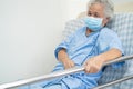 Asian senior or elderly old woman patient lie down handle the rail bed with hope on a bed in the hospital Royalty Free Stock Photo