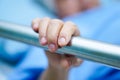 Asian senior or elderly old woman patient lie down handle the rail bed in the hospital. Royalty Free Stock Photo