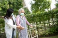 Asian senior or elderly old woman walk with walker and wearing a face mask for protect safety infection Covid-19 Coronavirus Royalty Free Stock Photo
