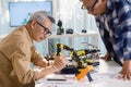 asian Senior engineer programming robot arm in automation and electronics technology lab