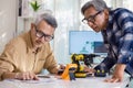 asian Senior engineer programming robot arm in automation and electronics technology lab Royalty Free Stock Photo