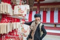 Asian senior female tourist in winter costume