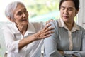 Asian senior grandmother reconcile touchy her granddaughter,angry upset woman with crossed arms,old elderly trying to reconcile by Royalty Free Stock Photo