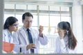Asian senior laboratory scientist man working at lab with asian young student scientist backgroud Royalty Free Stock Photo