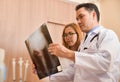 Asian doctors examining x-ray film of a patient. Royalty Free Stock Photo