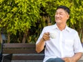 Asian senior man drinking hot coffee in garden. senior lifestyle concept Royalty Free Stock Photo