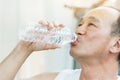 Asian senior man drinking water at a gym. Royalty Free Stock Photo