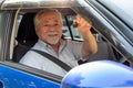 Asian senior man driver smiling and showing new car keys. Royalty Free Stock Photo