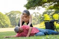 Asian senior man falling down from wheelchair on lying floor after trying push the wheelchair forward and Crying in pain and Royalty Free Stock Photo