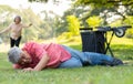 Asian senior man falling down from wheelchair on lying floor after trying push the wheelchair forward and Crying in pain and Royalty Free Stock Photo