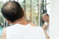 Asian senior man having pain on his shoulder and neck. Royalty Free Stock Photo