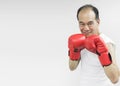 Asian senior man lifting dumbbell in gym. Royalty Free Stock Photo