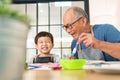 Asian Senior man and little boy Enjoying painting