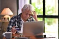 Asian senior man looking confuse when using credit card for online shopping