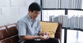 Asian senior man taking medicine on sofa at home Royalty Free Stock Photo