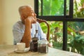 Asian senior man thinking about something Royalty Free Stock Photo