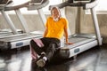 asian Senior man tired taking break after exercise sitting or resting on treadmill in fitness gym . walking  workout  . sport , Royalty Free Stock Photo