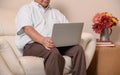 Asian Senior man using laptop and looking for Insurance after retirement. Grandfather stay alone Royalty Free Stock Photo