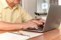 Asian Senior man using laptop and looking for Insurance after retirement. Grandfather stay alone Royalty Free Stock Photo