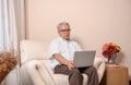 Asian Senior man using laptop and looking for Insurance after retirement. Grandfather stay alone Royalty Free Stock Photo