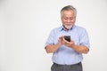 Asian senior man using smartphone isolated over white background. Royalty Free Stock Photo