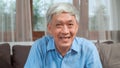 Asian senior man video call at home. Asian senior older Chinese male using mobile phone video call talking with family grandchild Royalty Free Stock Photo