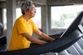 asian Senior man walking exercise on treadmill workout in fitness gym . sport , trainnig , retired , older , mature, elderly Royalty Free Stock Photo