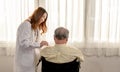 Asian Senior man was sick and sitting on wheelchair. The doctor check retirement age health Royalty Free Stock Photo