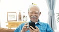 Asian Senior man with white mustache talking with smart phone Royalty Free Stock Photo