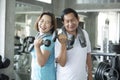 Asian senior man and woman exercise lifting dumbbell in fitness gym. elderly healthy lifestyle Royalty Free Stock Photo