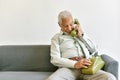 Asian senior old man telephone call their children, Lonely grandfather  talking with family on vintage phone at home. Royalty Free Stock Photo