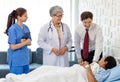 Asian senior old professional successful female doctor in white lab coat with stethoscope and internship nurse in blue uniform