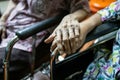 Asian senior people and old friends in wheelchair,holding hands to encourage each other in times of discouragement and despair,