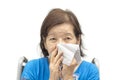 Asian senior woman blowing her nose Royalty Free Stock Photo